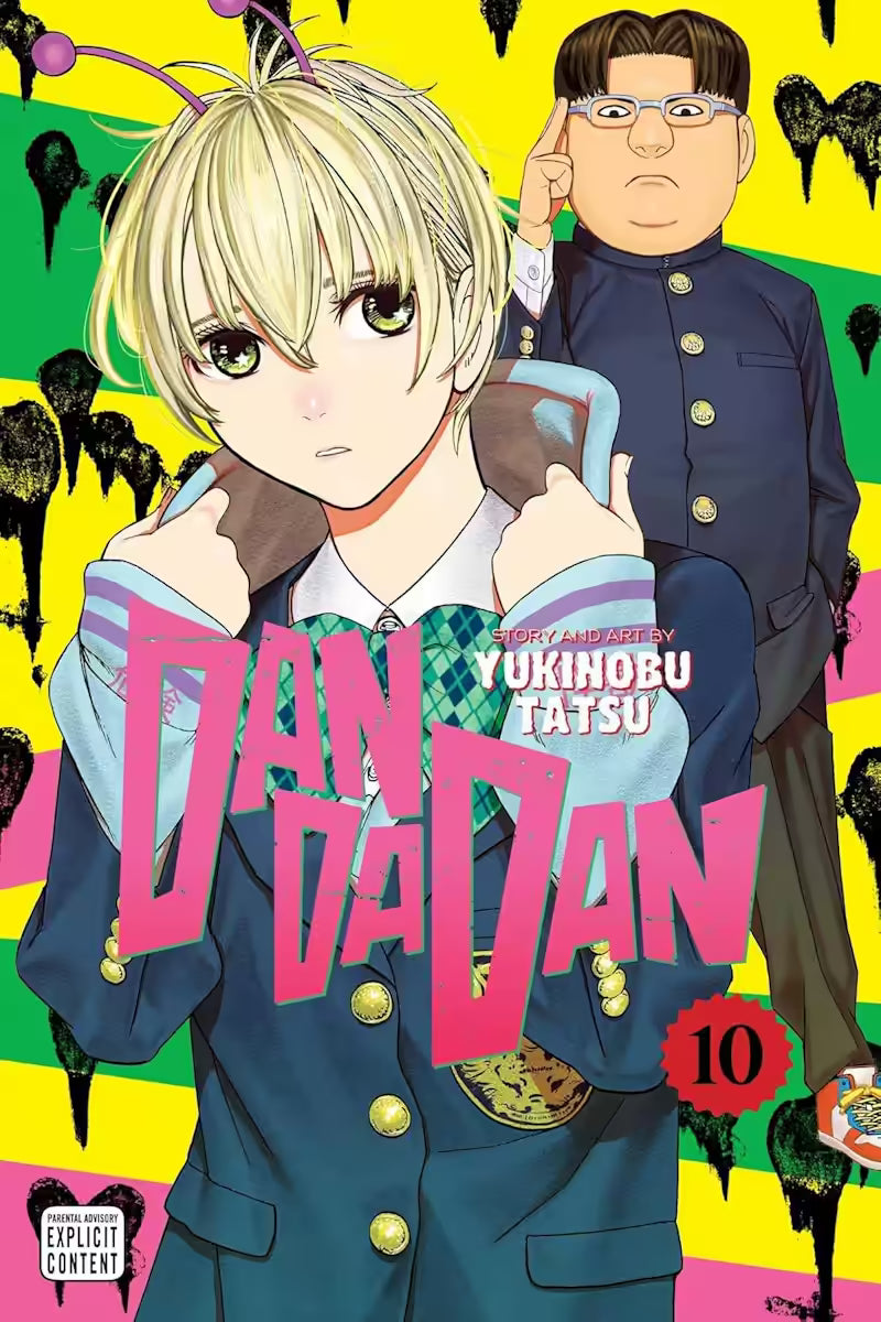 Manga forside til ‘Dandadan’ bind 10, der viser en person med lyst hår og antenner på hovedet i skoleuniform i forgrunden, mens en anden person i mørk uniform står bag mod en gul og grøn baggrund.
