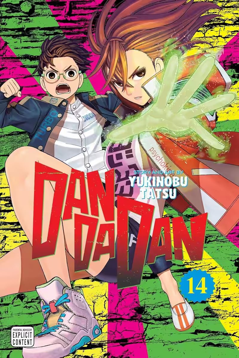 Manga forside til ‘Dandadan’ bind 14, der viser en ung kvinde med kraftigt udsvingende hår og en lysende grøn hånd, mens en ung mand med briller står bag hende mod en neonfarvet baggrund.