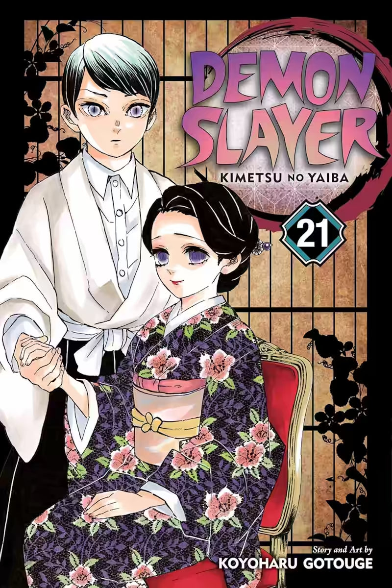 Image of Manga-forside til ‘Demon Slayer’ bind 21, der viser Tamayo siddende i en mønstret kimono, mens Yushiro står bag hende og holder hendes hånd. Begge er placeret foran en traditionel shoji-baggrund.
