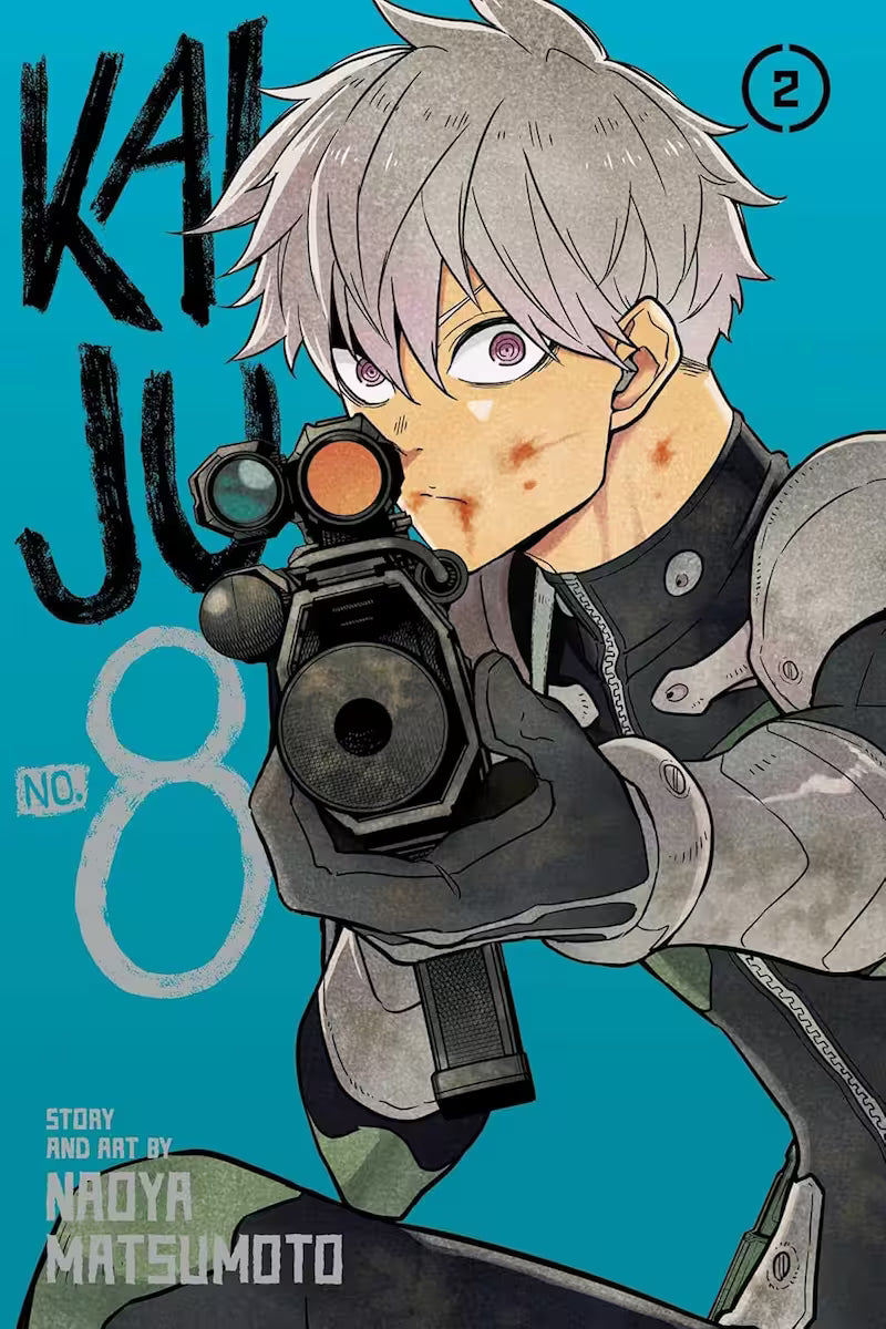 Manga-forside af Kaiju No. 8 bind 2 med Reno Ichikawa i kampstilling, sigtende direkte mod læseren med en taktisk riffel med kikkertsigte. Den blå baggrund understreger hans fokus og beslutsomhed.